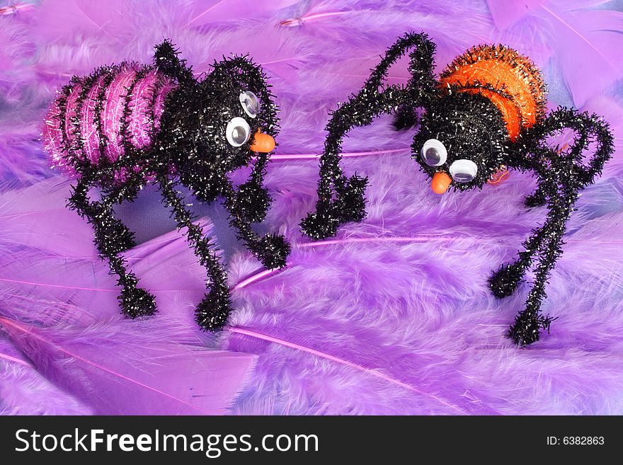 Colorful insects standing on a feathery background. Colorful insects standing on a feathery background