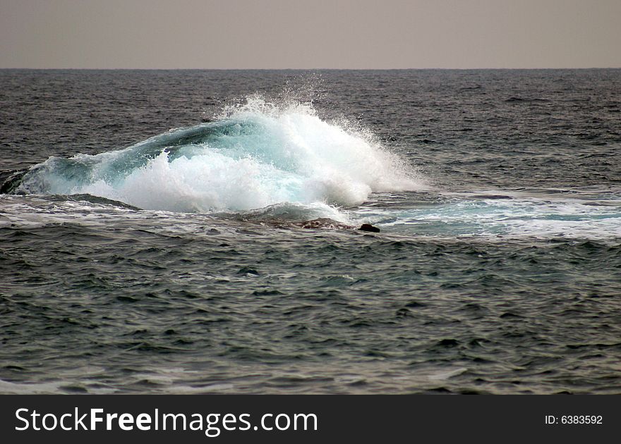 A wave in a bay in Majorca in Spain