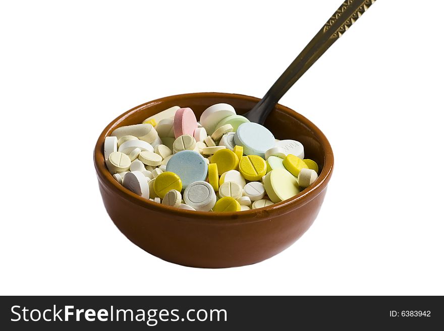 Isolated clay bowl of pills