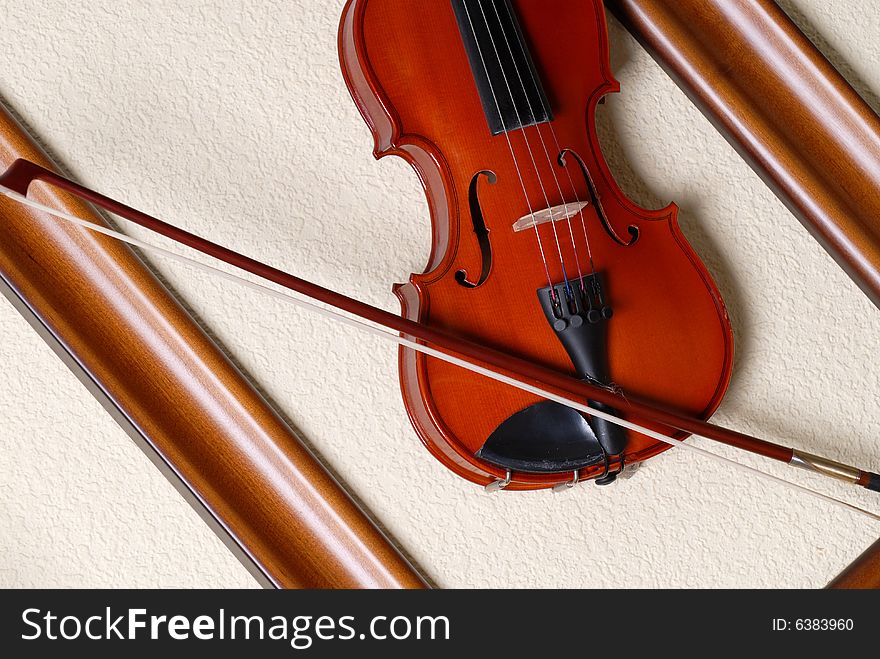 Violin and bow in a wooden framework