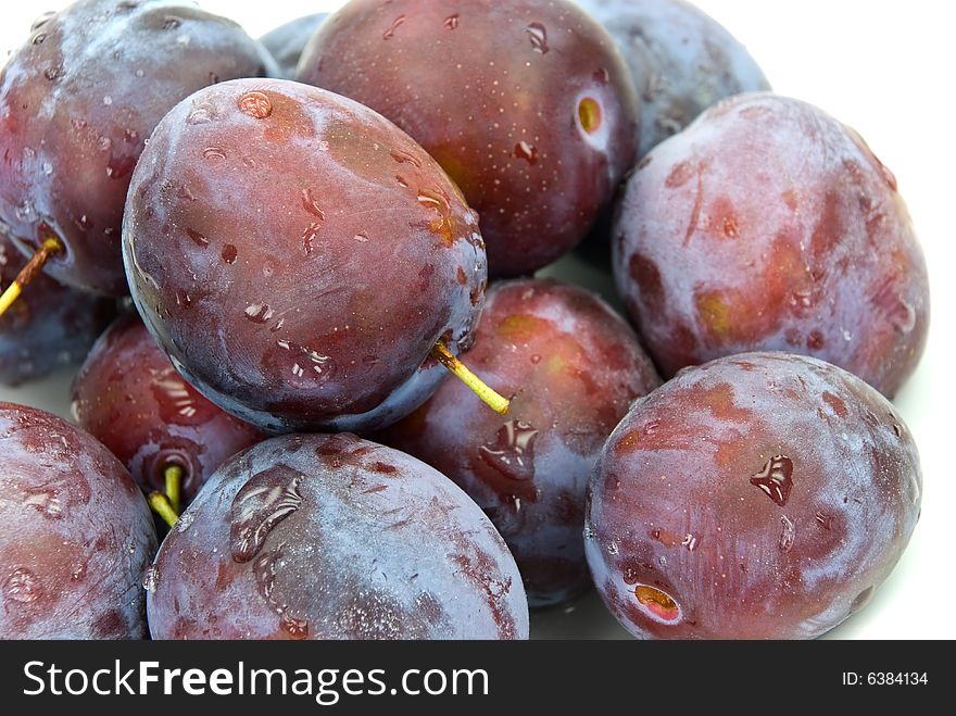 Stak of big , ripe plums.