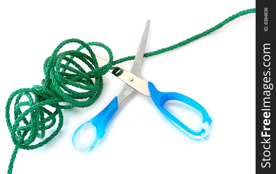 Green synthetic cord and steel scissors on overwhite background. Green synthetic cord and steel scissors on overwhite background.