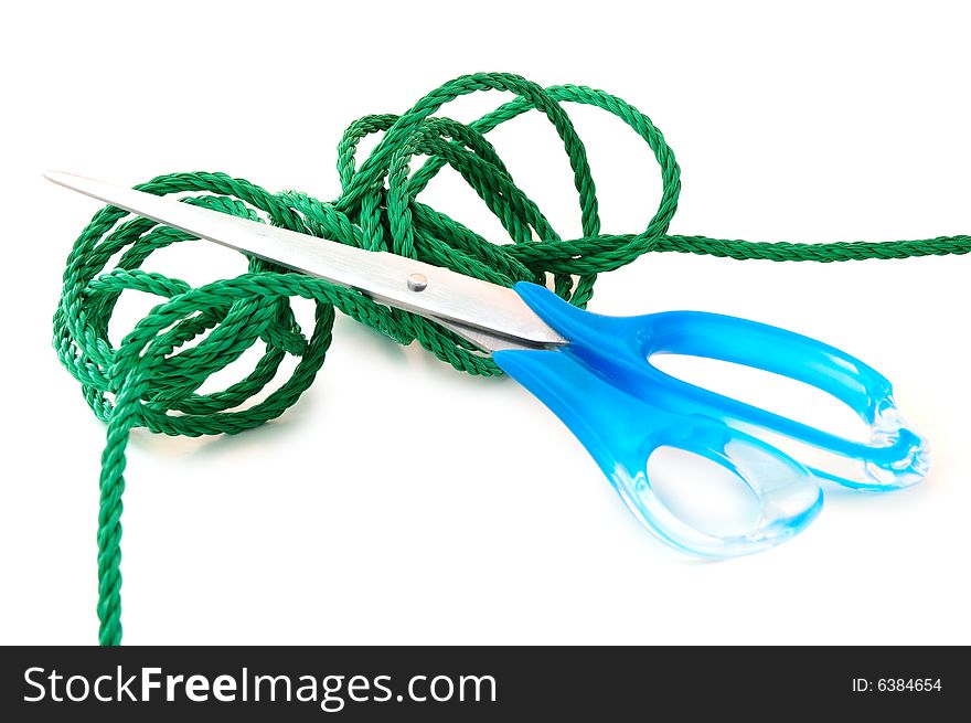 Green synthetic cord and steel scissors on overwhite background. Green synthetic cord and steel scissors on overwhite background.