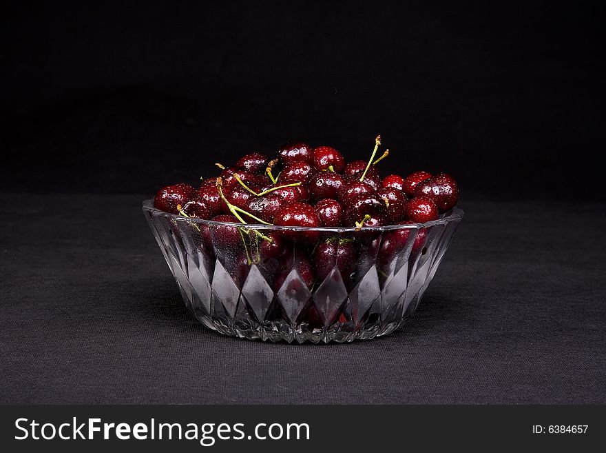 Shot of a freshly washed bowl of cherries in a crystal bowl.