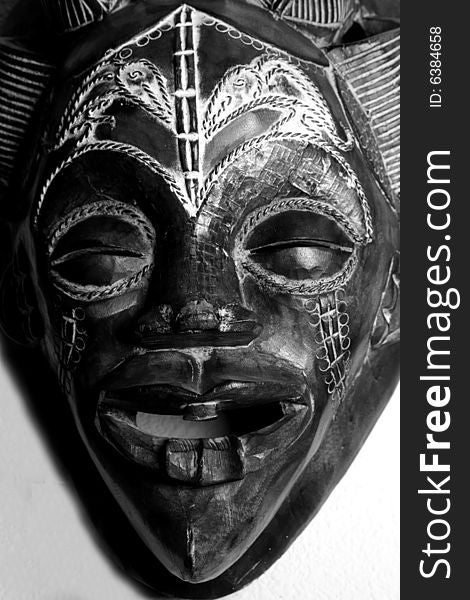 Black and White shot of a hand carved African Mask.