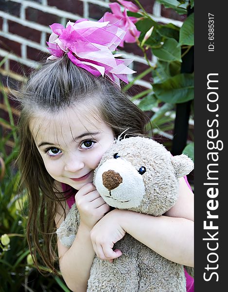 Beautiful Little Girl with her best friend, her teddy bear, in an outdoor setting. Beautiful Little Girl with her best friend, her teddy bear, in an outdoor setting.