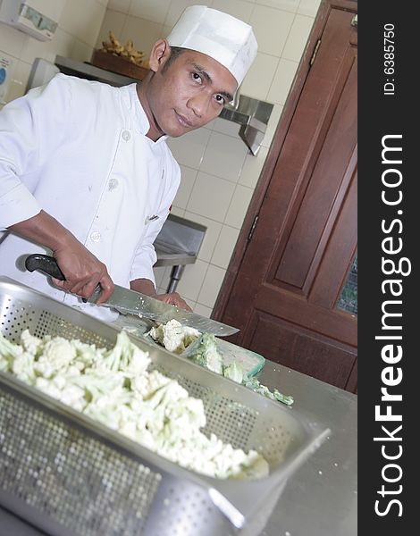 Photograph of chef cutting vegetable