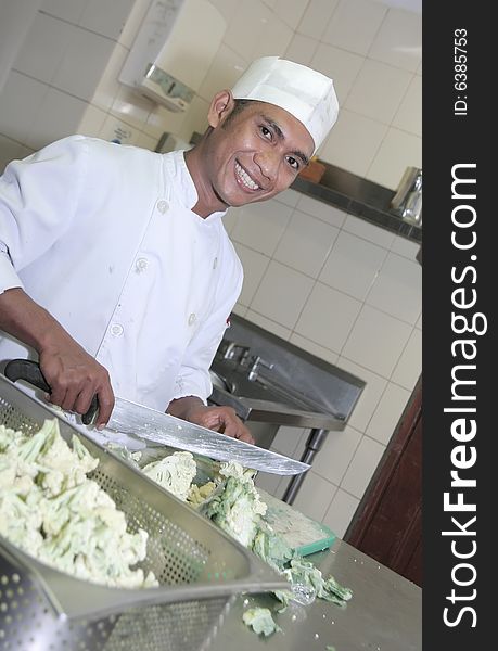 Chef at butcher, cutting vegetables