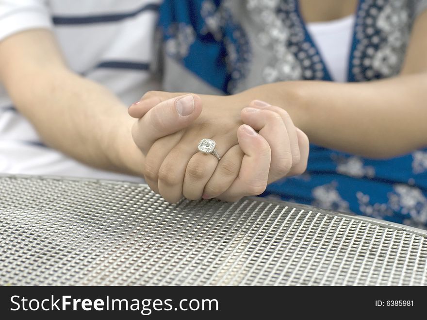 Close-up shot of engagement ring on woman's finger