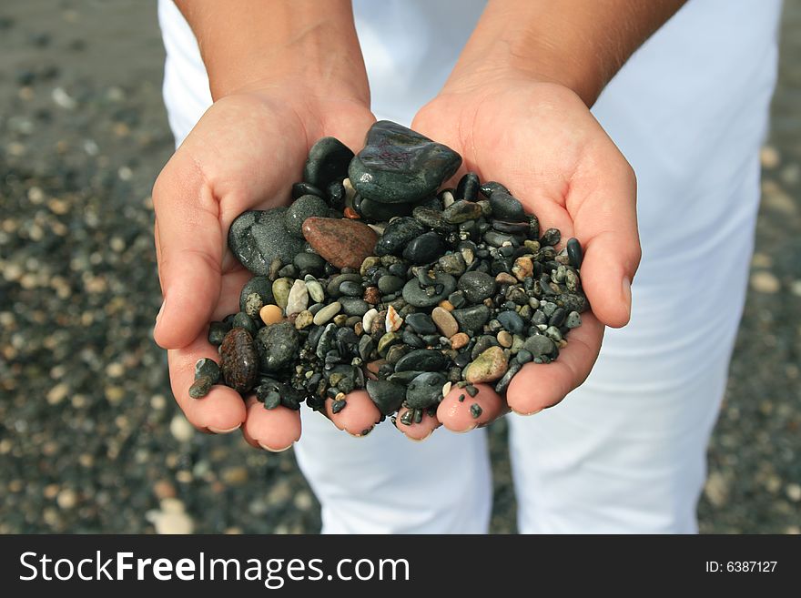 Closeup of hands holding pebbles. Closeup of hands holding pebbles