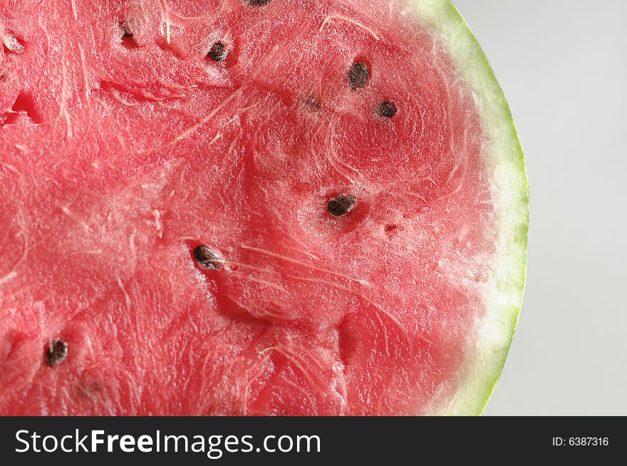 A cut of a ripe water-melon on a white background. A cut of a ripe water-melon on a white background.