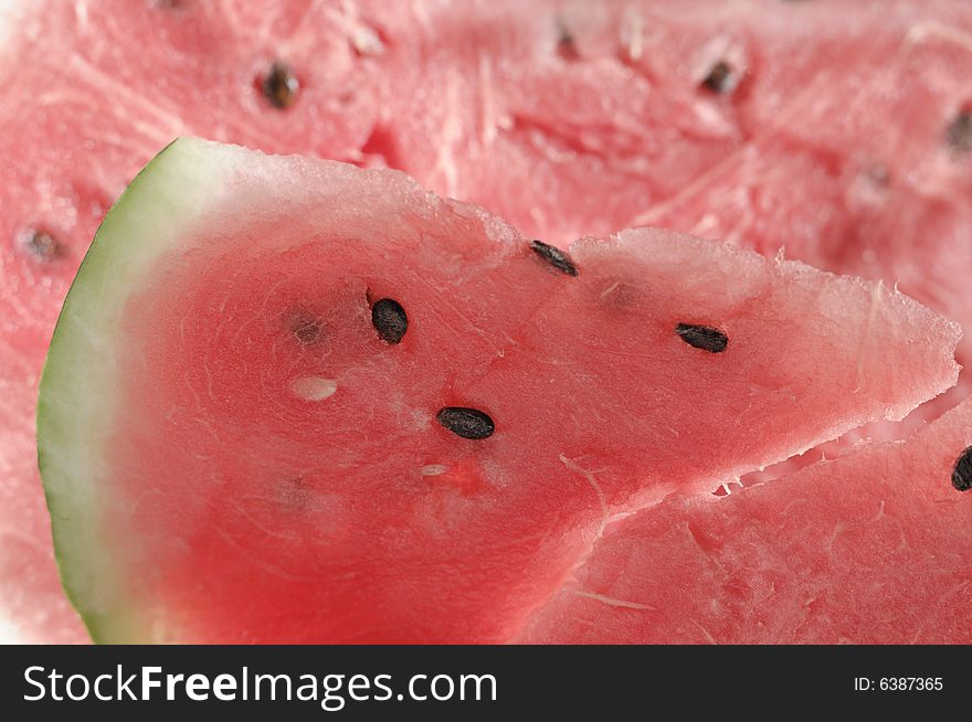 Piece of a ripe water-melon on a white background. Piece of a ripe water-melon on a white background.