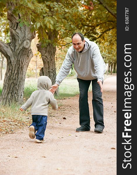 Father and son in autumn park. Father and son in autumn park