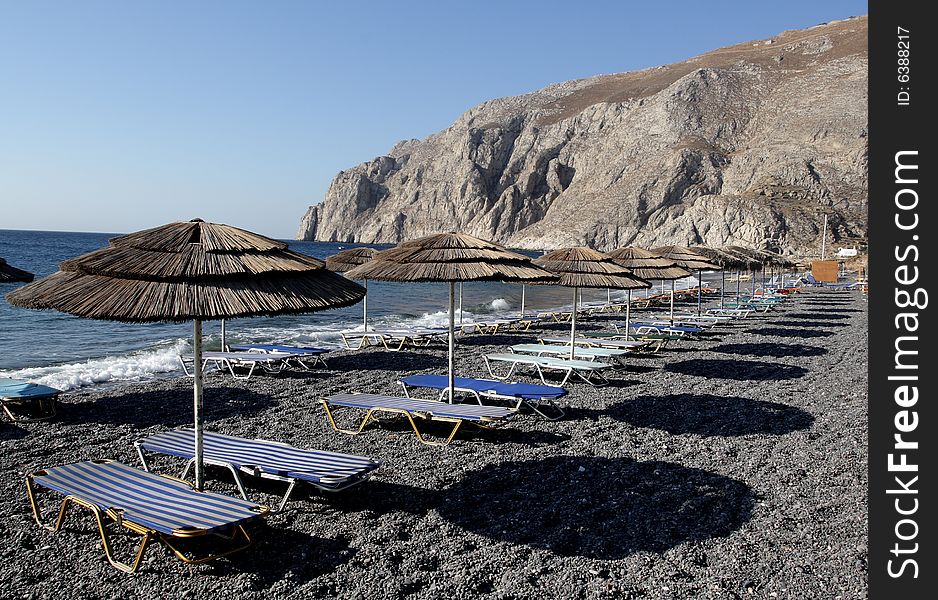 Beach umbrellas on Kamari beach in the morning