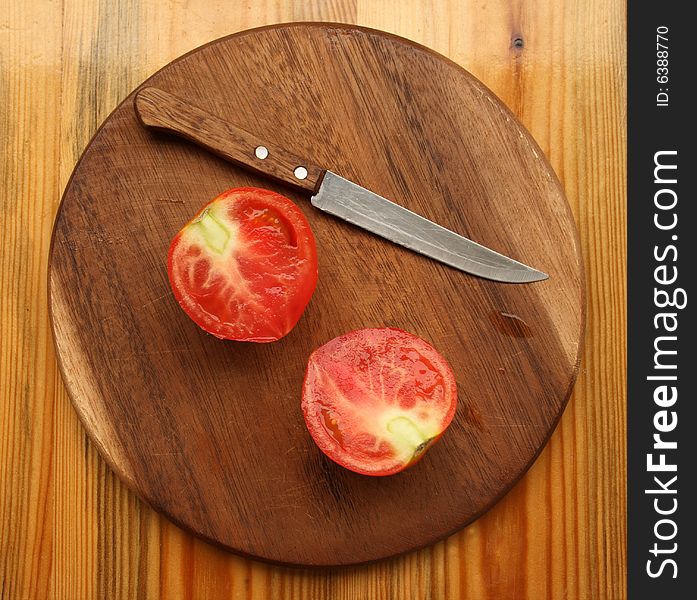 Fresh Tomato With Knife On Kitchen Board