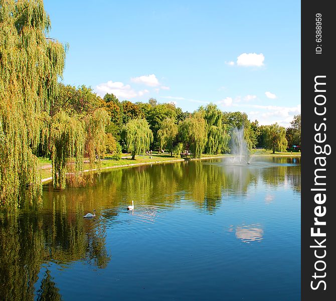 Picturesque autumn landscape of river and bright trees and bushes