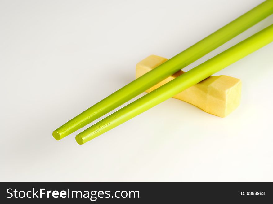 Japanese chopsticks on the support, are isolated on a white background.