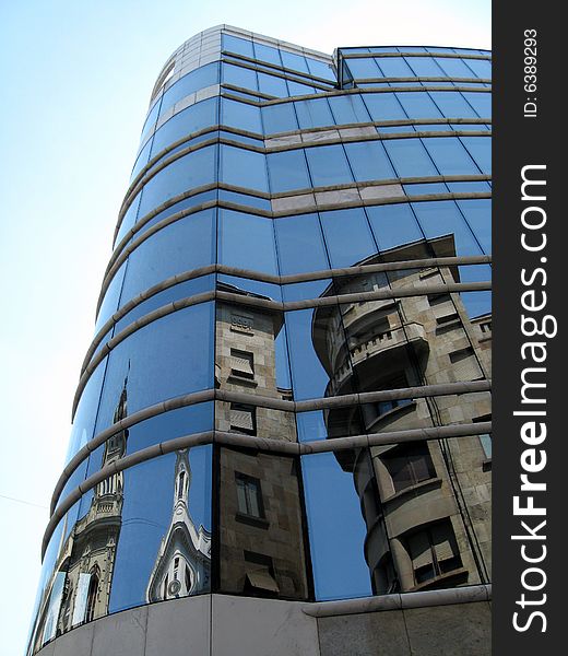 Reflection of the ancient house in a mirror wall of a modern building (Belgrade, Serbia)