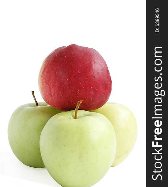 Red apple among green apples on a white background