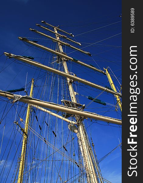 A ship mast against a blue sky