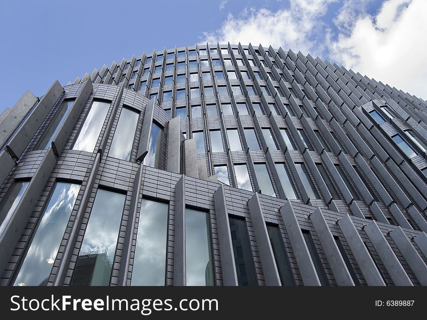 Modern glass building with sky reflections in the windows. Modern glass building with sky reflections in the windows