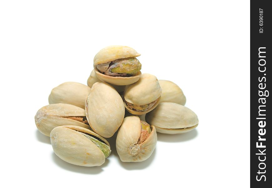 Salted pistachios isolated on white background.