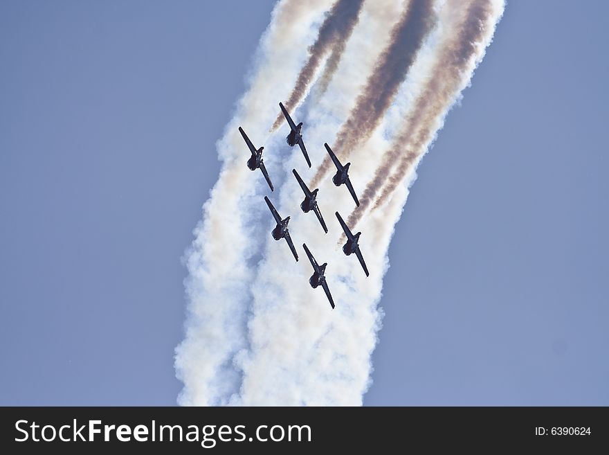 Stunt planes perform in tandem during an air show. Stunt planes perform in tandem during an air show