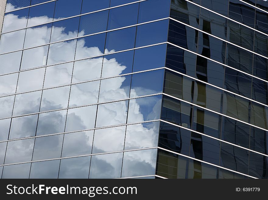 Clouds reflection in office building
