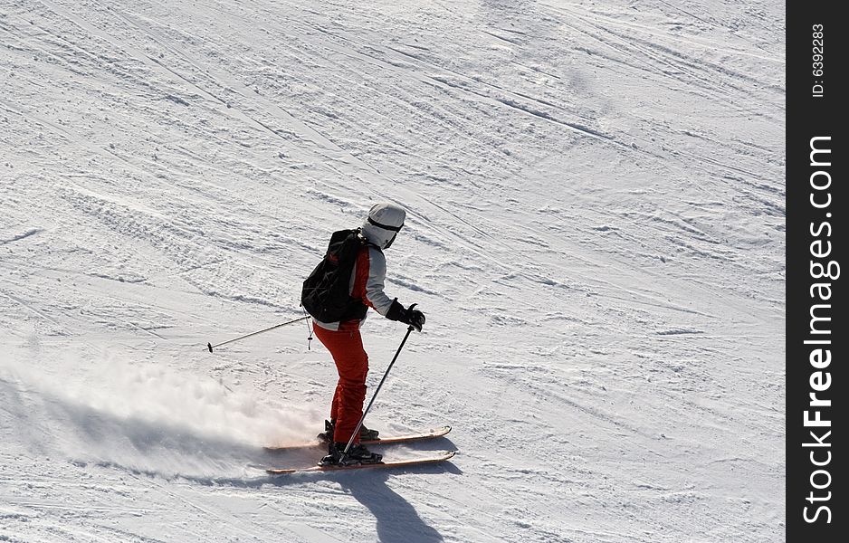Woman is skiing at a ski resort. Woman is skiing at a ski resort