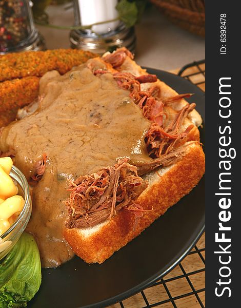 Open beef sandwich with gravy, macaroni and fried pickles. Open beef sandwich with gravy, macaroni and fried pickles.