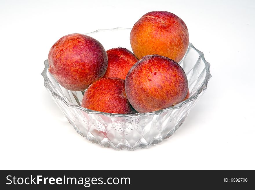 Shot of a freshly washed bowl of peaches in a crystal bowl.