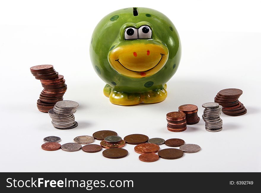 Piggy bank in the shape of a frog with piles of cash. Piggy bank in the shape of a frog with piles of cash