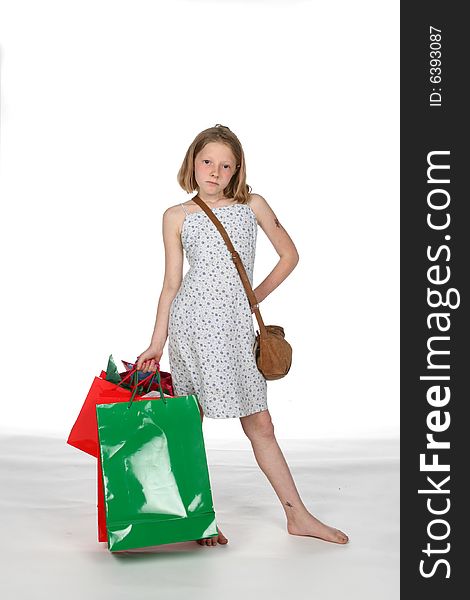 Girl in dress holding her red and green Christmas shopping bags. Girl in dress holding her red and green Christmas shopping bags