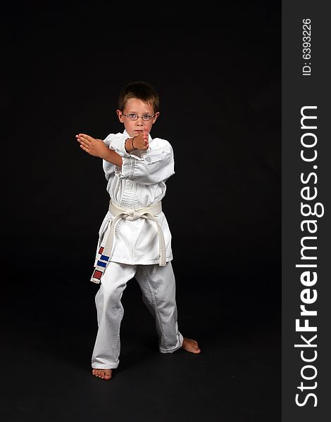 Traditional karate student demonstrating hand block and right stance. Traditional karate student demonstrating hand block and right stance