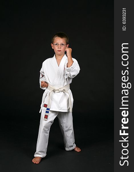 Traditional karate student demonstrates double bone block and right stance