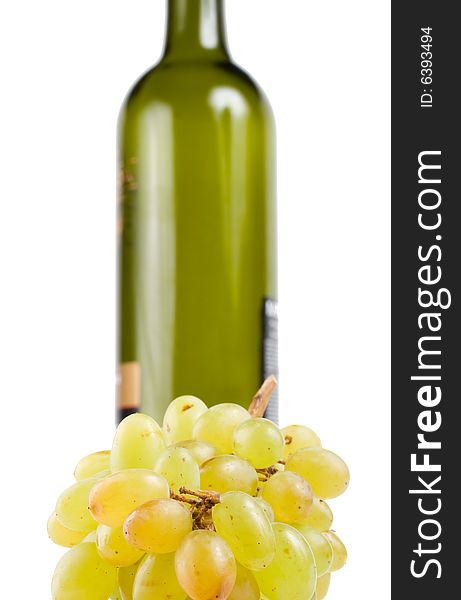 Close-up bottle and green grapes, isolated on white