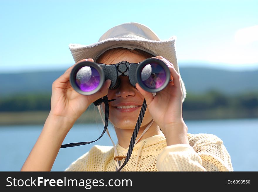 Woman with the binoculars over a mountains