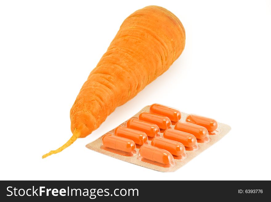 Vitamin pills with carrot on isolated white. Make your choice. Vitamin pills with carrot on isolated white. Make your choice