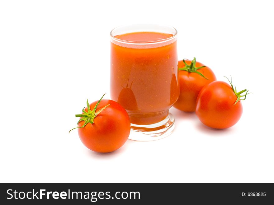 Glass of tomato juice and tomatoes