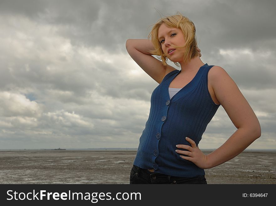 Pretty blond on stormy day at seaside