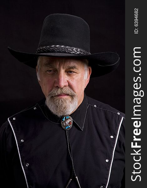 Shot of an older western man with a string tie.