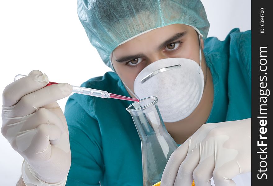 Scientist taking a probe in a labor scene with testtubes and beaker Shallow DOF the Focus is on the little bottle and the hand