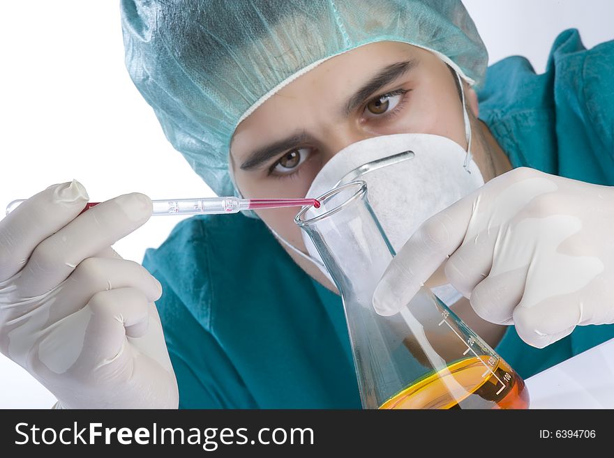 Scientist taking a probe in a labor scene with testtubes and beaker Shallow DOF the Focus is on the little bottle and the hand