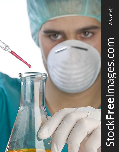 Scientist taking a probe in a labor scene with testtubes and beaker Shallow DOF the Focus is on the little bottle and the hand