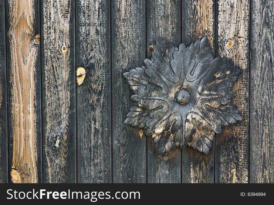Wooden wall decorated with traditional flower-shape ornament. Wooden wall decorated with traditional flower-shape ornament