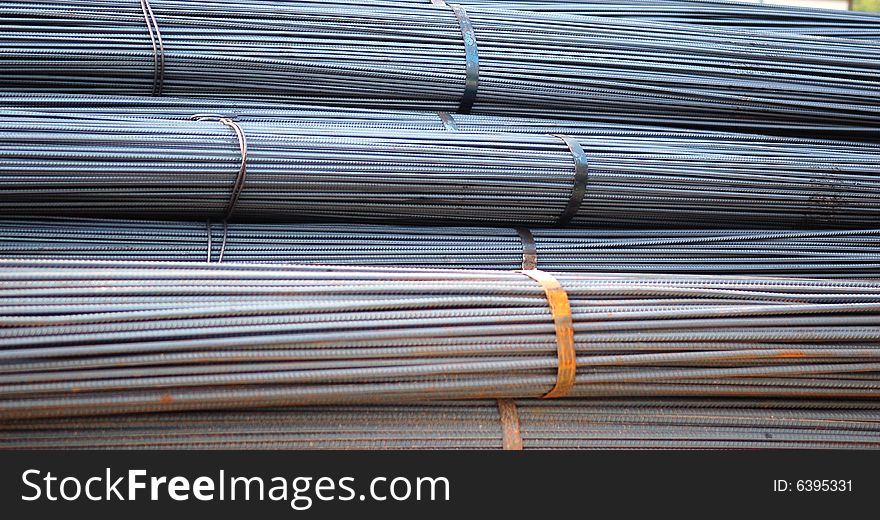 A tied bundle of cold steel bars on construction site