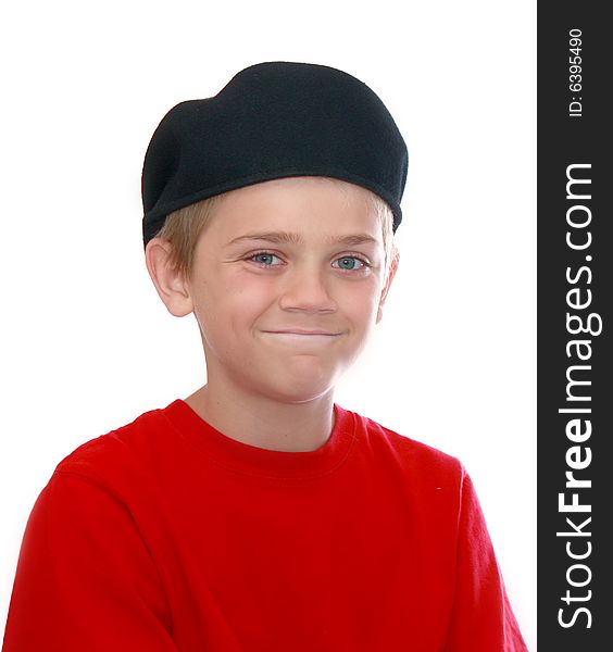 Cute young boy wearing a backwards cap and a red tee-shirt isolated on white. Cute young boy wearing a backwards cap and a red tee-shirt isolated on white.