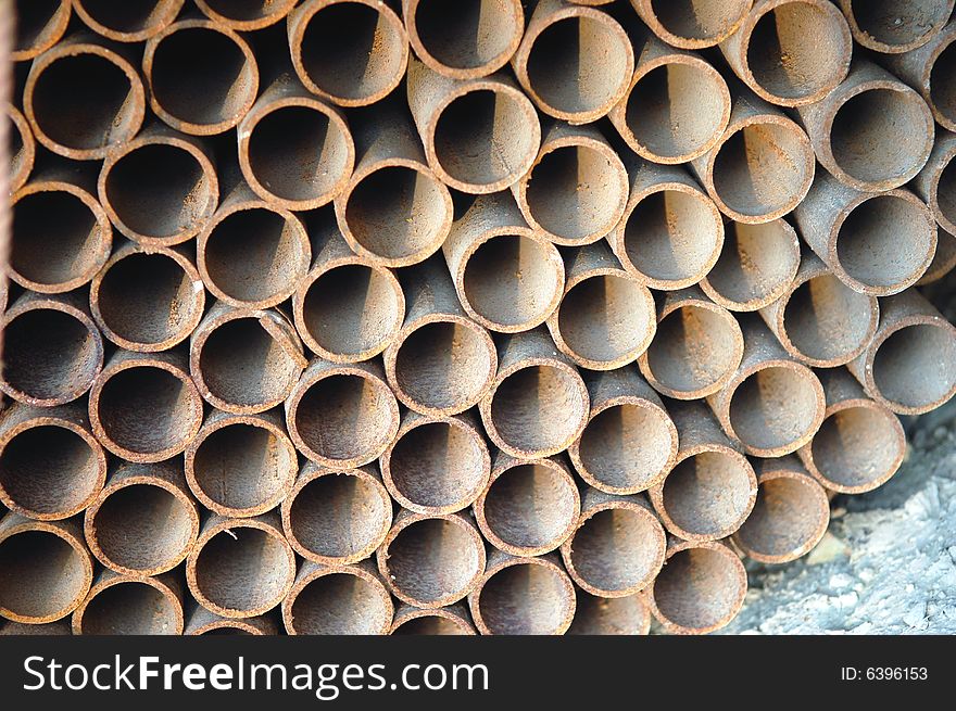 Abstract close up of a stack of steel pipes on construction site