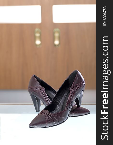 Photo of elegant shoes with glass and wood in the background. Photo of elegant shoes with glass and wood in the background