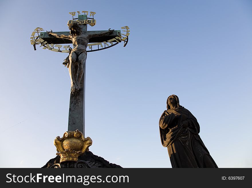 Sunset view on statuary of the Calvary Cross (Crucifix from 1629, statues by Emanuel Max 1861) standing on Charles Bridge.